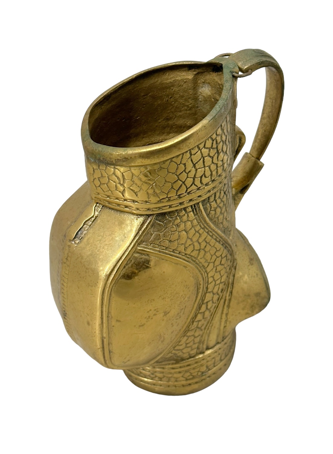 Close-up of vintage brass golf bag vase with intricate designs.