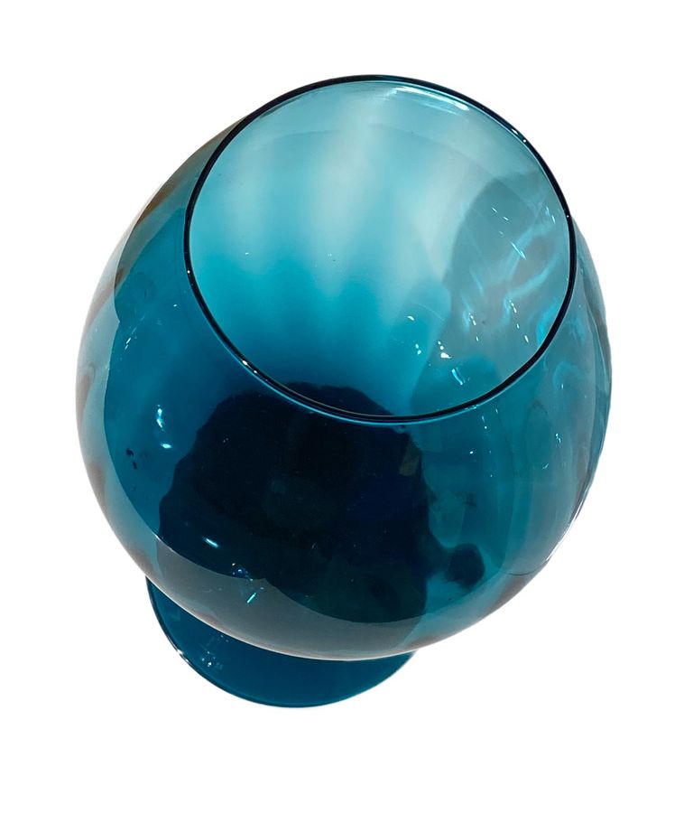 Close-up of vintage Italian blue glass vase with elegant stemmed design.