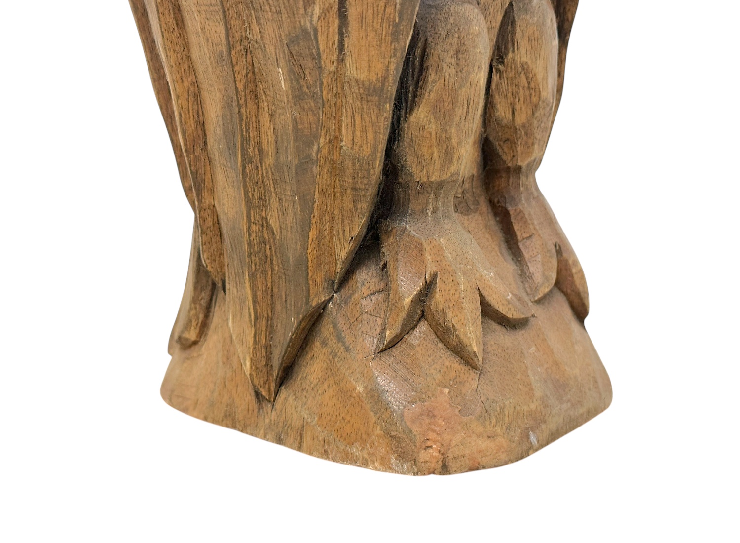 Close-up of vintage carved wooden owl with intricate feather detailing.