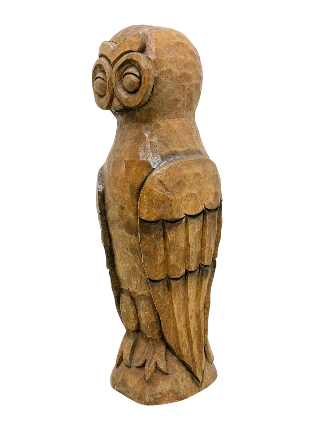 Close-up of handcrafted wooden owl figurine with intricate details and rich brown tones.