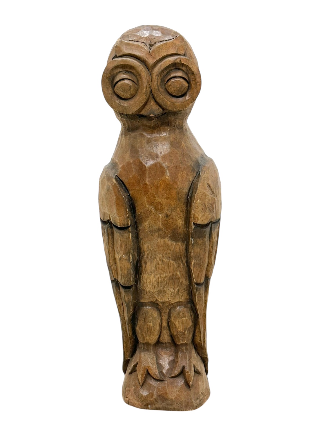 Close-up of vintage carved wooden owl with intricate detailing and rich brown hues.