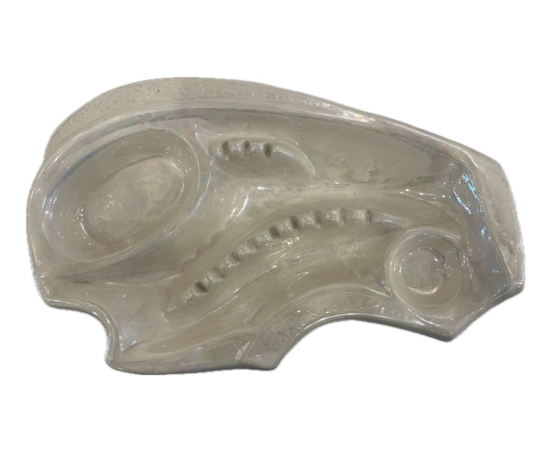 Close-up of vintage ivory ceramic ashtray with intricate design, circa 1970s.