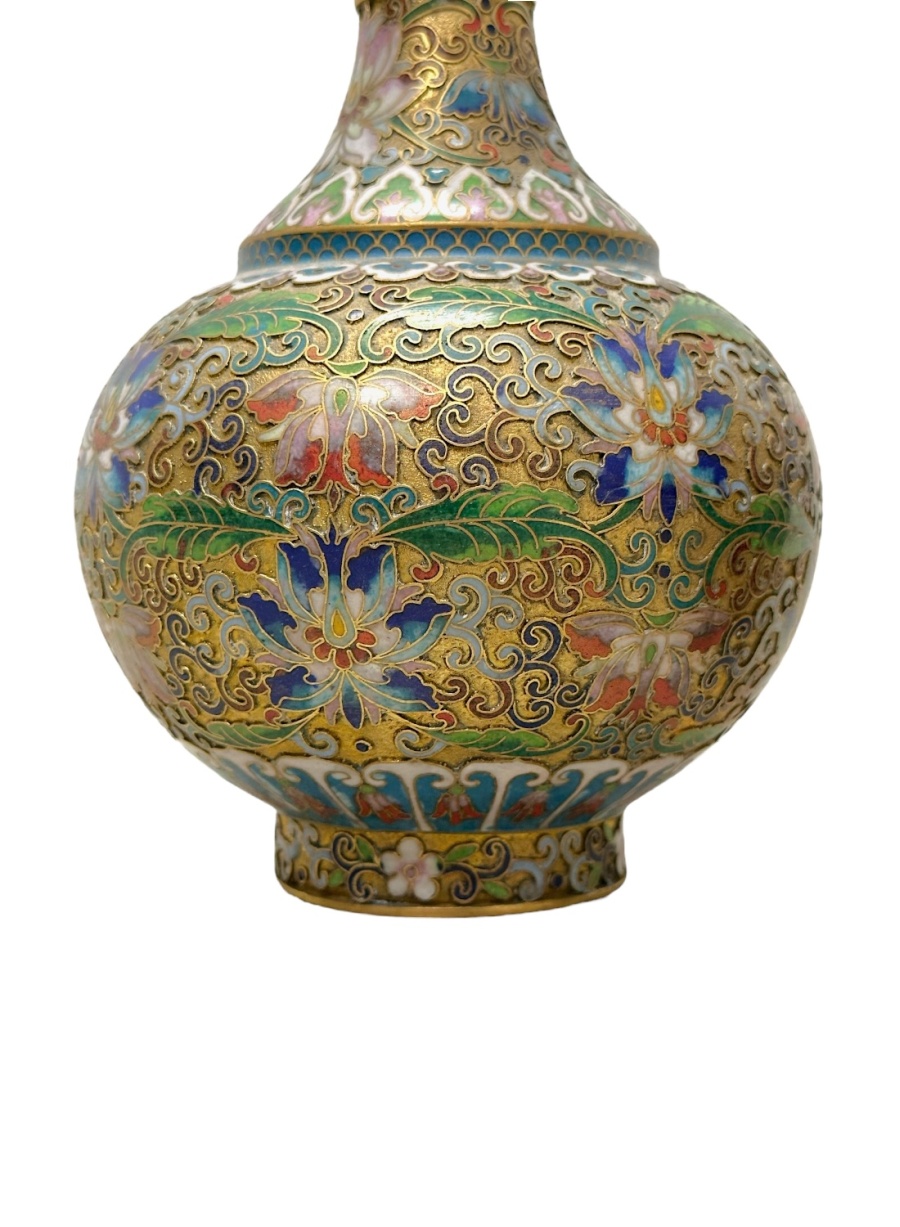 Close-up of intricately designed Chinese cloisonné vases featuring vibrant colors and detailed patterns.