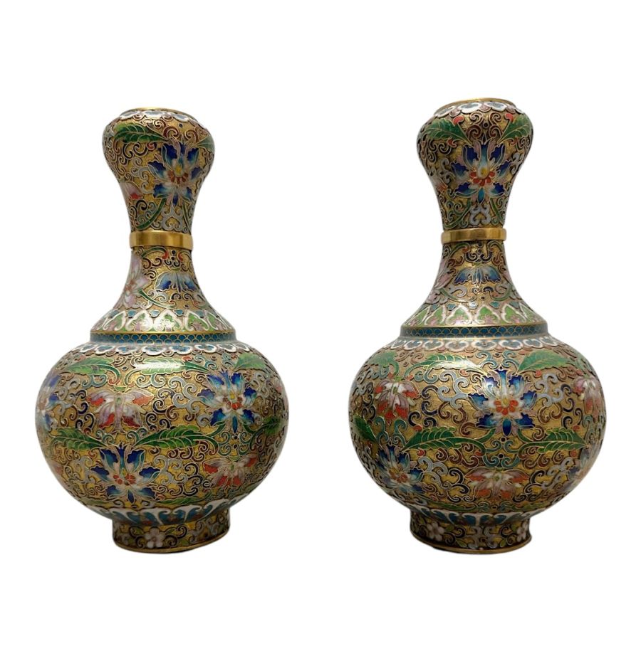 Pair of ornate Chinese cloisonné vases with intricate floral patterns and brass accents.