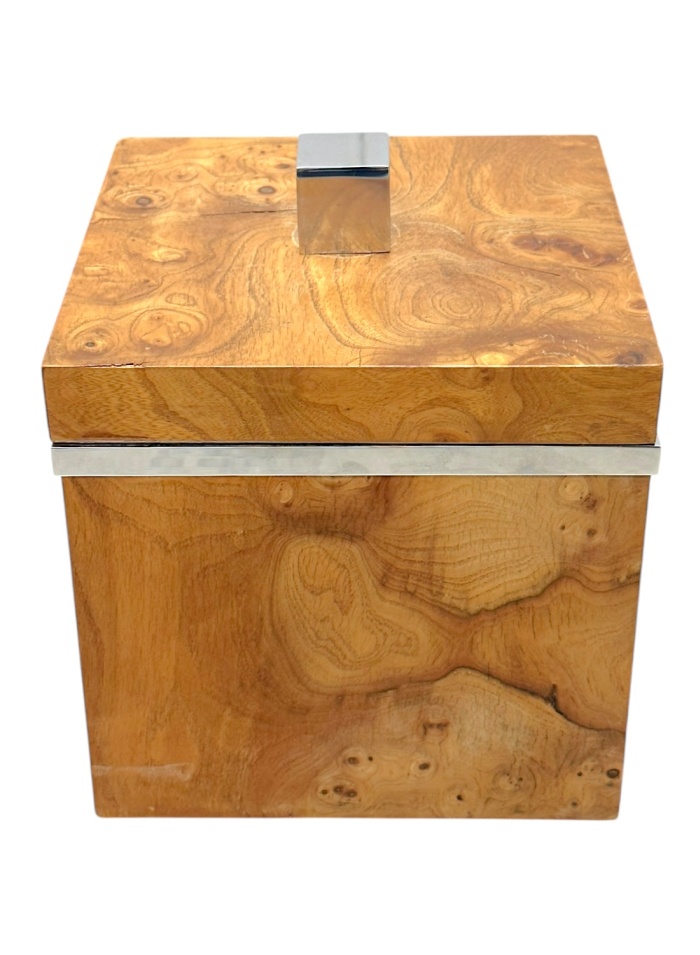 Close-up of vintage chrome ice bucket featuring intricate burlwood design.