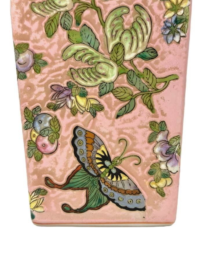 Side view of vintage pink Chinoiserie vases featuring intricate fruit, flower, and butterfly motifs.
