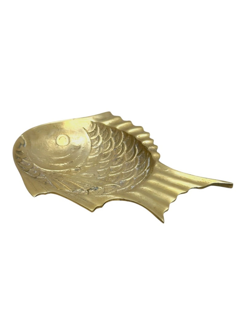 Close-up of vintage brass fish dish, showcasing intricate details and golden hue.