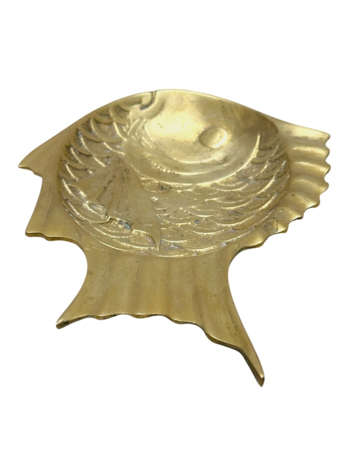 Close-up of antique brass fish dish with intricate designs and detailed patterns.